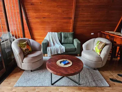 a living room with two chairs and a coffee table at Betulio's Oasis in Fortuna