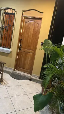 a wooden door of a house with plants in front at Enchanted sonido de la selva in Quepos