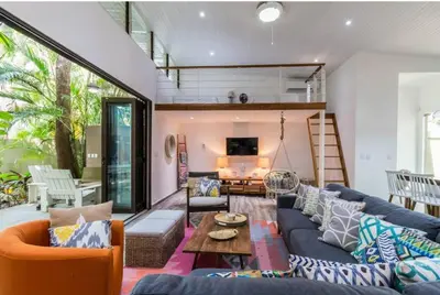 a living room with blue couches and a table at Oceano 5 - Walk to the beach in Playa Pelada