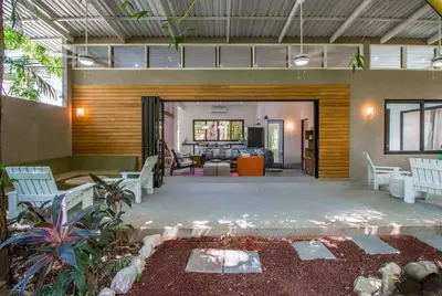 a living room with white chairs and a couch at Oceano 5 - Walk to the beach in Playa Pelada