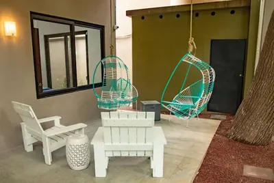 a patio with two chairs and a swing at Oceano 5 - Walk to the beach in Playa Pelada