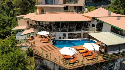 an aerial view of a house with a swimming pool at Issimo Suites (Adults Only) in Manuel Antonio