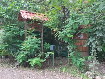 a small house with a sign that says garden at Casa Rosada Nosara in Nosara