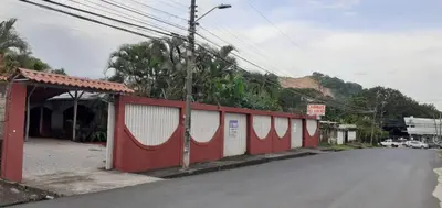 a red and white fence on the side of a street at Las cabinas del sueño in Nicoya