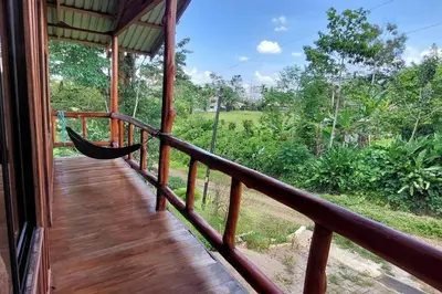 a hammock on the porch of a house at Cabaña Finca el Corteza in Fortuna