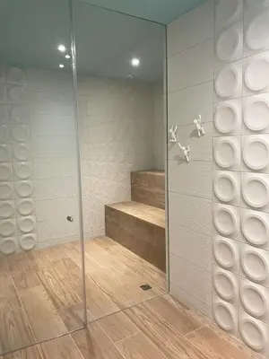 a walk in shower with a glass door at CityScape Properties 20th floor Studio 24-7 Concierge Amenities in San José