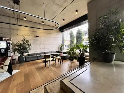 a lobby with a couch and chairs and potted plants at CityScape Properties 20th floor Studio 24-7 Concierge Amenities in San José