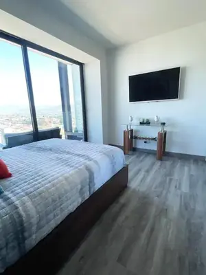 a bedroom with a bed and a flat screen tv at CityScape Properties 20th floor Studio 24-7 Concierge Amenities in San José
