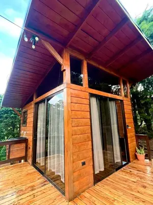 a house with a large glass door on a deck at Cypress House Costa Rica in San Cristóbal Norte