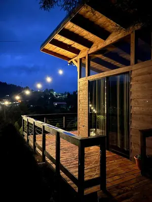 a wooden deck with awning on a house at night at Cypress House Costa Rica in San Cristóbal Norte