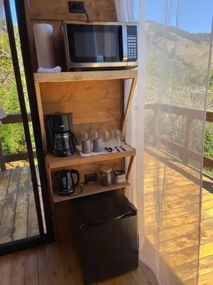 a microwave sitting on a shelf next to a balcony at Cypress House Costa Rica in San Cristóbal Norte