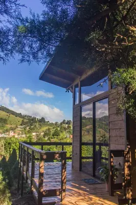 a wooden deck with a glass door on a building at Cypress House Costa Rica in San Cristóbal Norte