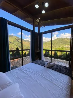 a bedroom with a bed with a view of mountains at Cypress House Costa Rica in San Cristóbal Norte