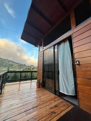 a balcony of a house with a wooden deck at Cypress House Costa Rica in San Cristóbal Norte