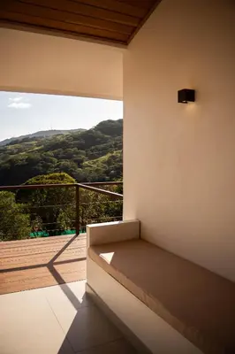 a room with a bed and a balcony with a view at Finca Aquarius in Monteverde Costa Rica