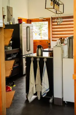 a kitchen with a stove with towels hanging from it at Finca Aquarius in Monteverde Costa Rica