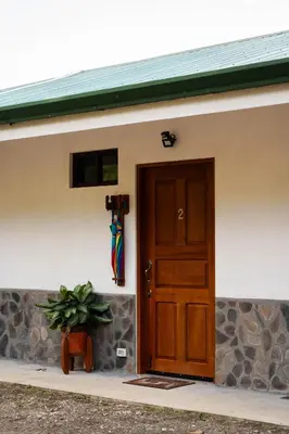 a door of a house with a plant next to it at Finca Aquarius in Monteverde Costa Rica