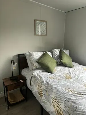 a bedroom with a bed with green pillows on it at Gaspar Arenal Volcano in Fortuna