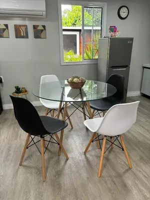 a dining room with a glass table and chairs at Gaspar Arenal Volcano in Fortuna