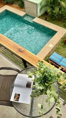 a pool with a table and a glass table sidx sidx sidx at Z orro Tropical in Arbolito