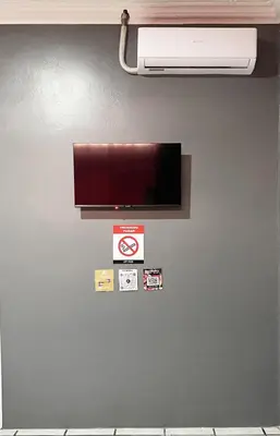 a wall with a flat screen tv on a wall at San Isidro, Perez Zeledon - Hotel Dubai in San Isidro