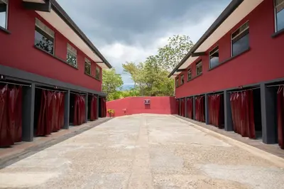 an alley between two red buildings with red curtains at San Isidro, Perez Zeledon - Hotel Dubai in San Isidro