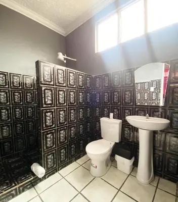 a bathroom with a toilet and a sink at San Isidro, Perez Zeledon - Hotel Dubai in San Isidro