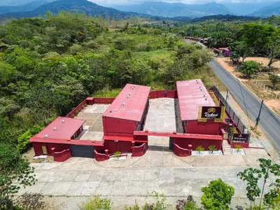 an overhead view of two red picnic tables on a hill at San Isidro, Perez Zeledon - Hotel Dubai in San Isidro