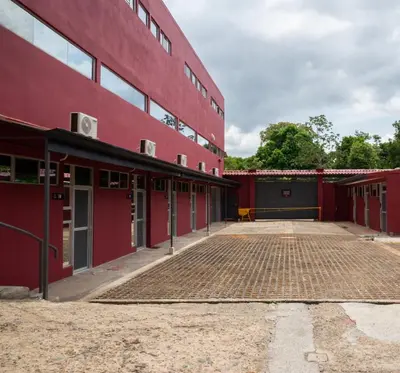 a red building with a brick parking lot at San Isidro, Perez Zeledon - Hotel Dubai in San Isidro