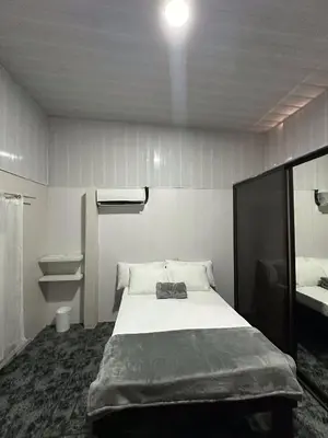 a bedroom with a large bed and a sink at Casa Buen Agüero in San Antonio