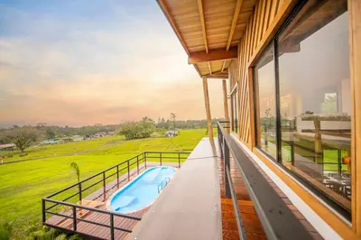 a view from the balcony of a house with a swimming pool at Two Volcanoes Villa Fortuna in Fortuna