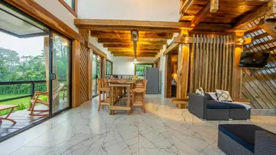 a living room with a table and chairs at Two Volcanoes Villa Fortuna in Fortuna