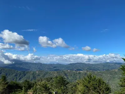 a view of the mountains with a blue sky and clouds at Cabaña Aurora – COZY Cabin with an Amazing view! in San Pablo