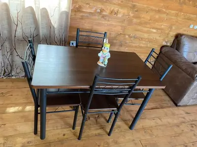 a wooden table and chairs with a teddy bear on it at Cabaña Aurora – COZY Cabin with an Amazing view! in San Pablo