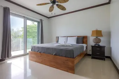 a bedroom with a bed and a large window at Diamante del Sol 303S- 3rd Floor Ocean View in Jacó