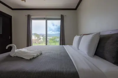 a bedroom with a large bed with a swan on it at Diamante del Sol 303S- 3rd Floor Ocean View in Jacó