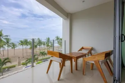 a dining room with a table and chairs and a view of the beach at Diamante del Sol 303S- 3rd Floor Ocean View in Jacó