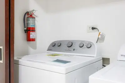 a fire extinguisher is on top of a washing machine at Diamante del Sol 303S- 3rd Floor Ocean View in Jacó