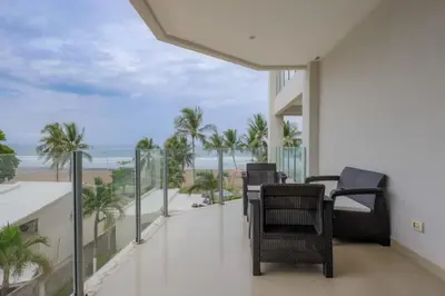 a balcony with chairs and a view of the beach at Diamante del Sol 303S- 3rd Floor Ocean View in Jacó