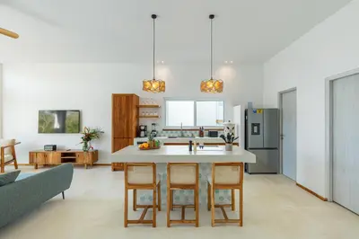a kitchen with a table and chairs in a room at Stylish ocean view Villa Blume at Hermosa Hills in Playa hermosa
