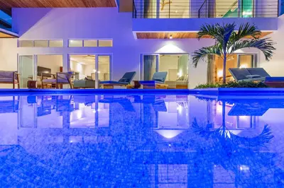 a swimming pool in the middle of a house at Stylish ocean view Villa Blume at Hermosa Hills in Playa hermosa