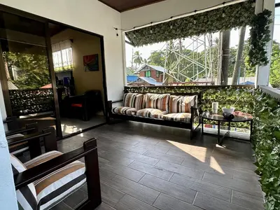 a living room with a couch and a window at Beautiful View House in Tortuguero