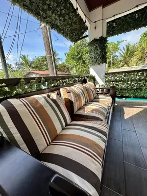 a row of pillows sitting on a patio at Beautiful View House in Tortuguero