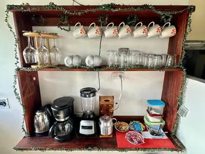 a shelf with wine glasses and other items on it at Beautiful View House in Tortuguero
