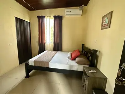 a bedroom with a large bed with a window at Beautiful View House in Tortuguero