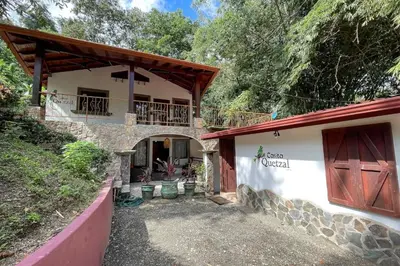 an external view of a house with a balcony at Restful Casa Quetzal Luxurious Rainforest Retreat in Quepos