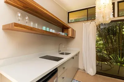 a kitchen with a sink and a window at Restful Casa Quetzal Luxurious Rainforest Retreat in Quepos