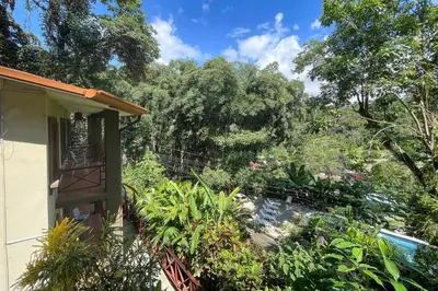 a garden outside a house with trees in the background at 2BR Eco Condo 1 AC 5MINS to Medical Center in Quepos