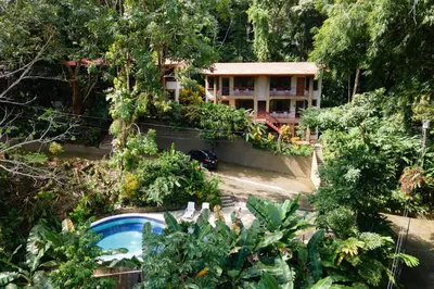 an aerial view of a resort with a pool and trees at 2BR Eco Condo 1 AC 5MINS to Medical Center in Quepos