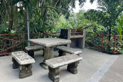 a picnic table and benches on a patio at EcoCondo 5 in Secured Community Paradise w pool in Quepos